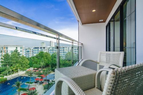 a balcony with a view of a pool and buildings at Amari Hua Hin in Hua Hin
