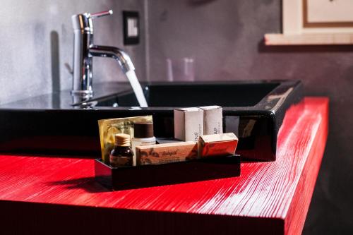 a bathroom sink with a soap dispenser next to it at La Villa Desenzano in Desenzano del Garda