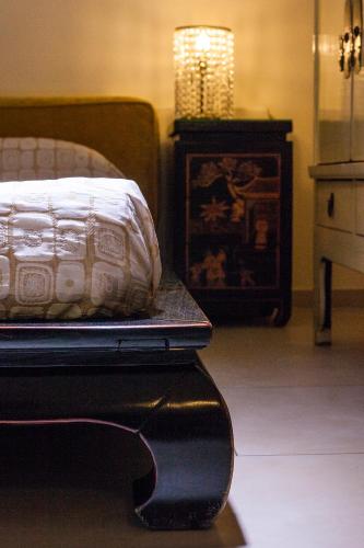 a bedroom with a bed and a dresser and a table at La Villa Desenzano in Desenzano del Garda
