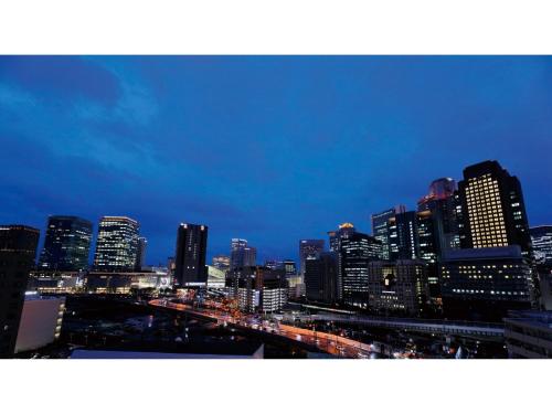 a view of a city skyline at night at DEL style Osaka Shin Umeda by Daiwa Roynet Hotel in Osaka