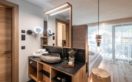 a bathroom with a sink and a mirror at Viel Nois Guest House in Funes