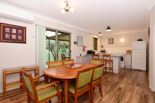 a kitchen and dining room with a table and chairs at Valley Haven 3 bedrooms close to the village in Kangaroo Valley