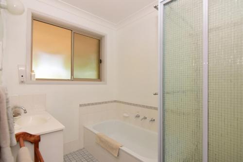 y baño con bañera, lavamanos y ducha. en Valley Haven 3 bedrooms close to the village en Kangaroo Valley