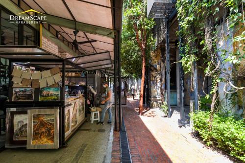 a man standing in front of a store on a street at Belakang KongHeng By DreamScape in Ipoh