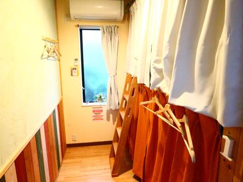 a hospital room with a bed and a window at ホステル富士山 結 in Fujiyoshida