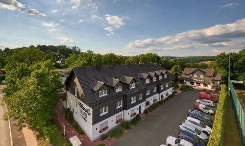 an overhead view of a building with cars parked in a parking lot at Hotel Pfeffermühle in Siegen