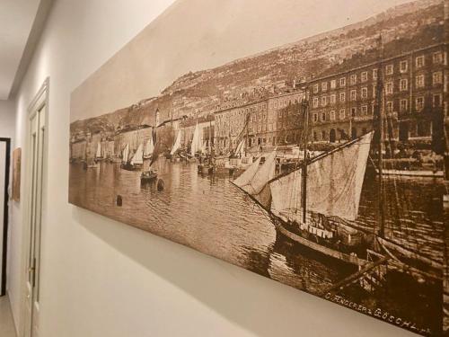 a painting of a harbor with boats in the water at Plaza Teatro & Piazzale Teatro in Rijeka