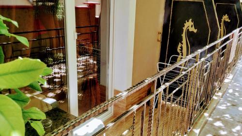 a room with a window with a cage in it at Dracena Guesthouse in Ravda