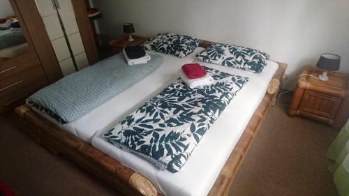 a bedroom with a bed with two phones on it at Ferienwohnung Am Stadtpark in Suhl