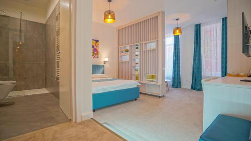 a bedroom with a bed and a shower and a bathroom at Zoom Rooms in Braşov