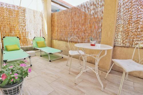a patio with two chairs and a table and chairs at Dida Boža House in Vodice
