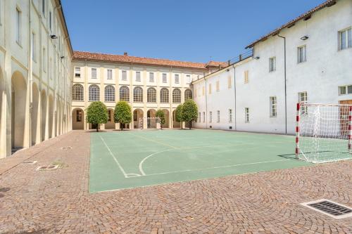 a tennis court in front of a building at Il Seminario in Alba