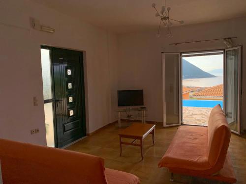 a living room with a couch and a view of the ocean at Aegli in Vasiliki