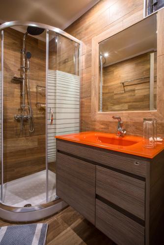 a bathroom with a red sink and a shower at MEGA AMMOS HOTEL in Syvota