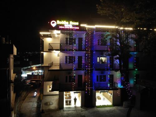 a building with christmas lights on it at night at Hotel Buddha House Himalayan Brothers in Dharamshala