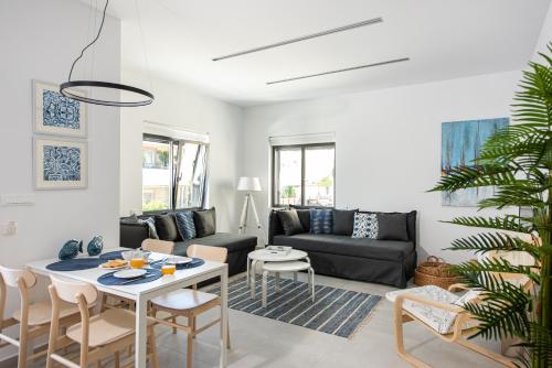 a living room with a couch and a table at Cozy Corner Luxury Apartments in Chania Town