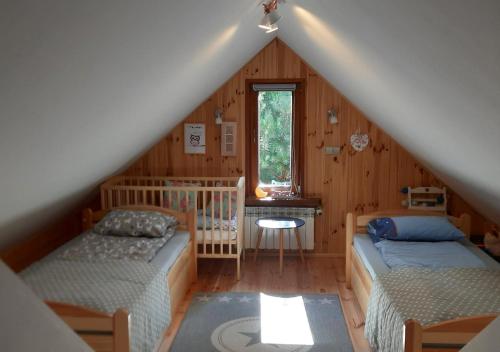 Säng eller sängar i ett rum på Pod Dębem Bis