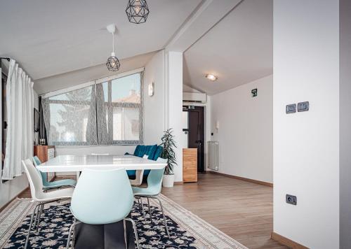a dining room with a white table and chairs at Istriana boutique apartment in Nova Gorica