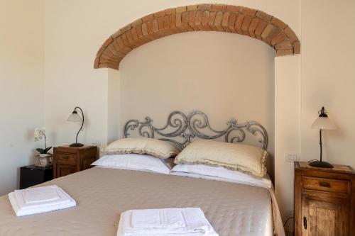 a bedroom with a large bed with two pillows at Agriturismo San Marcello in Castiglione dʼOrcia