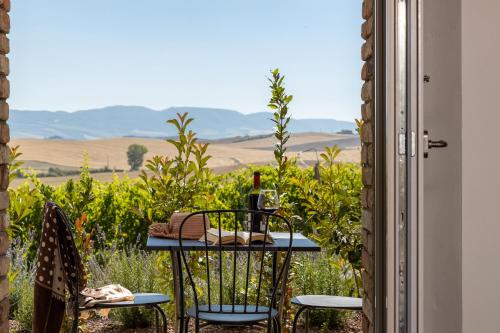 a table with a bottle of wine sitting on top of it at Agriturismo San Marcello in Castiglione dʼOrcia