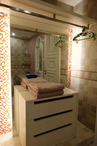 a bathroom with a bed on a counter with a mirror at Marrakesh Huahin Condo in Hua Hin