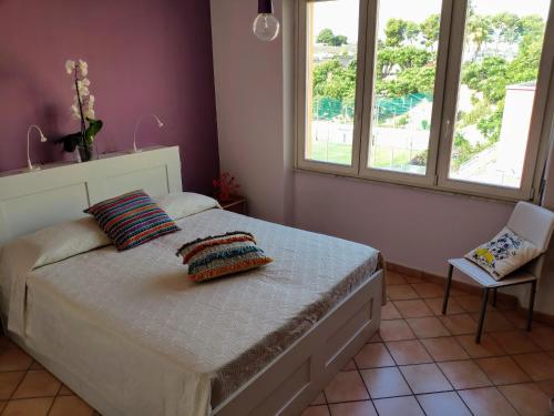 a bedroom with a bed with two pillows on it at Your home in Bonaria in Cagliari