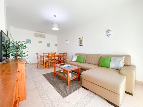 a living room with a couch and a table at Casa do Farol - Lagos in Lagos