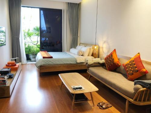 a living room with a bed and a couch at Khe Suites 06BR Private House near Lotte-Asia Park - Self Check-in with Lockbox in Danang