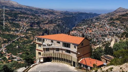 a building on the side of a mountain at Hotel L'Aiglon in Bcharr&eacute;