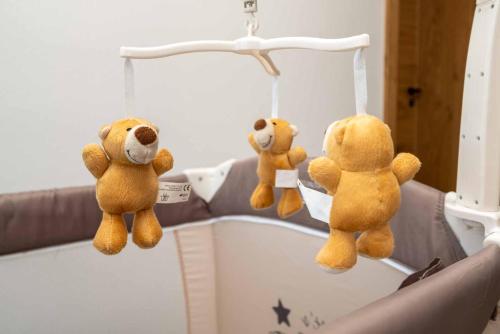 two stuffed teddy bears hanging from a hospital bed at Gasthaus Hotel Beim Erich in Oberhofen am Irrsee