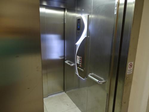 a stainless steel elevator with a sign on it at Gästehaus Uezel in Friedrichshafen