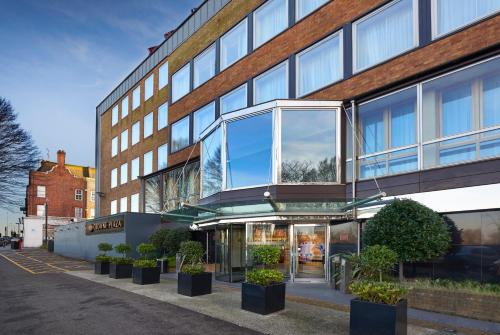 
a row of windows in front of a building at Crowne Plaza London Ealing, an IHG Hotel in London

