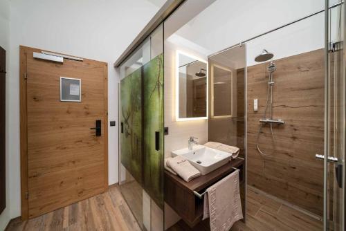 a bathroom with a sink and a shower at Gasthaus Hotel Beim Erich in Oberhofen am Irrsee