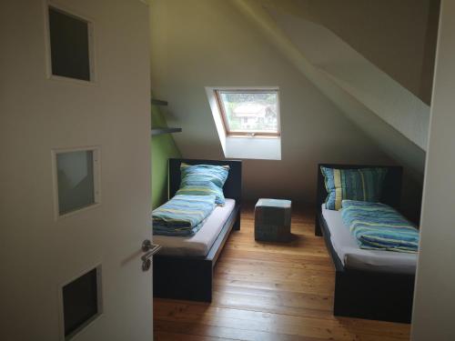 a room with two beds in the attic at Haus Fleur in Neustadt an der Weinstraße