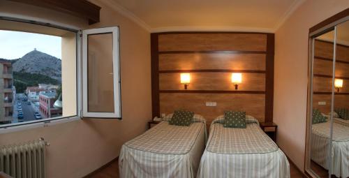 Postel nebo postele na pokoji v ubytování Hotel Odon