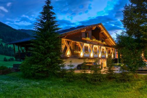 a log house with lights on the side of it at Nockberge Lodge in Bad Kleinkirchheim