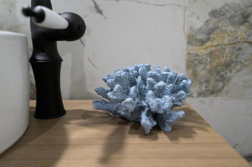 a blue sponge sitting on a table next to a lamp at The Well View in Preveza