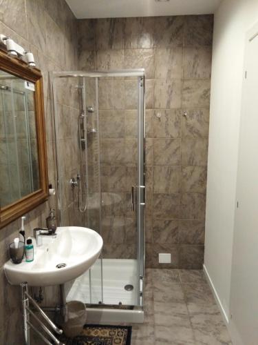 a bathroom with a sink and a shower at Palace B&B in Acquaviva delle Fonti