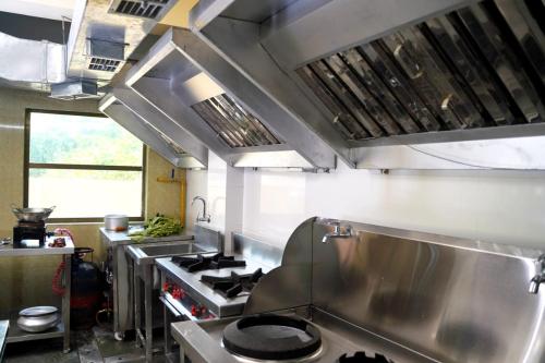 a kitchen with a stove top oven in a kitchen at Hotel Royal Sunview in Digha