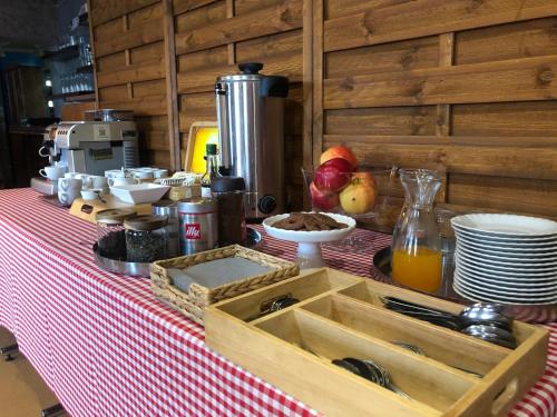 a table with a red and white table cloth with a wooden box at Hotel Azyl in Gorzów Wielkopolski