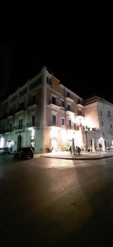 a large building is lit up at night at Palace B&B in Acquaviva delle Fonti