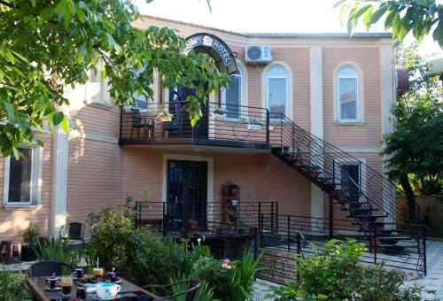 a house with a staircase in front of it at Hotel Casa calda in Kutaisi