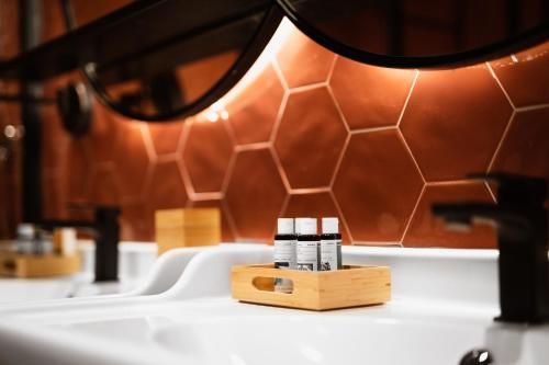 a table with a lamp on top of a sink at The Bold Type Hotel, a Member of Design Hotels in Patra