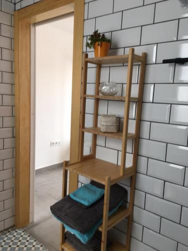 une étagère en bois contre un mur avec des serviettes. dans l'établissement Casa Sol y Luz - casa rural, à Carboneras