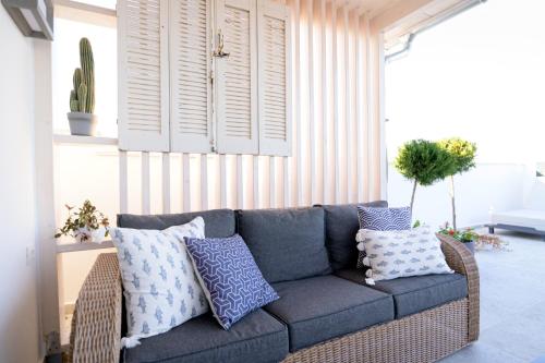 a blue couch with pillows in a living room at The Well View in Preveza