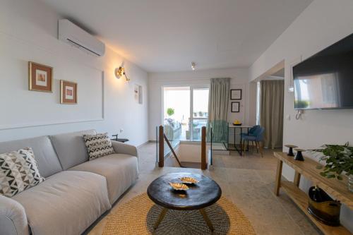 a living room with a couch and a table at The Well View in Preveza