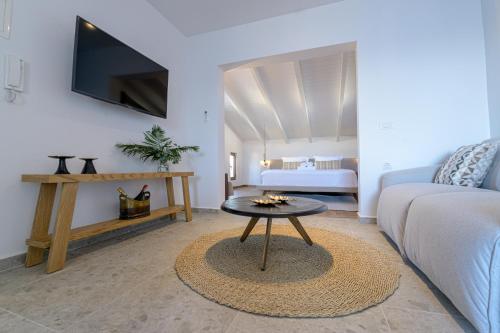 a living room with a couch and a table at The Well View in Preveza