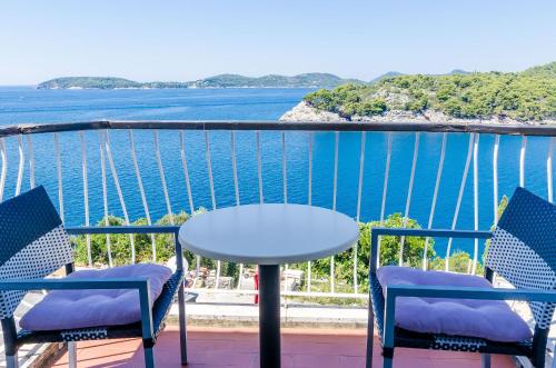 a table and chairs on a balcony overlooking the water at Villa Paradiso 2 in Dubrovnik