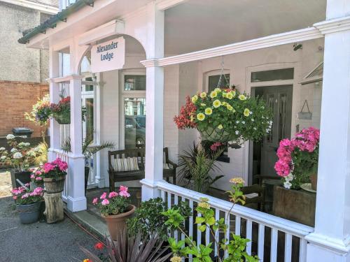 a flower shop with potted plants on a porch at Alexander Lodge in Bournemouth