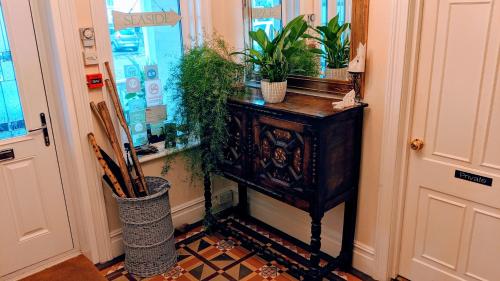 a hallway with a table with plants on it at Alexander Lodge in Bournemouth